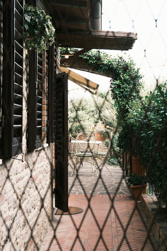 Outdoor patio with table and chairs behind fence